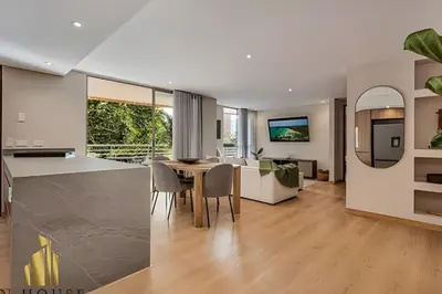 a kitchen and living room with a table and chairs at La Mannuela 505 - Stylish Living in El Poblado in El Poblado