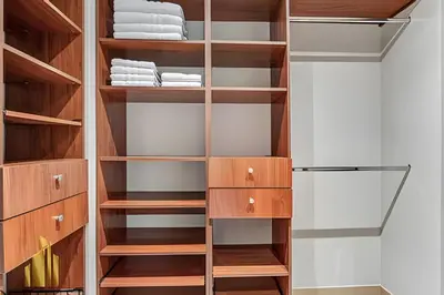 a walk in closet with wooden shelves and cabinets at La Mannuela 505 - Stylish Living in El Poblado in El Poblado