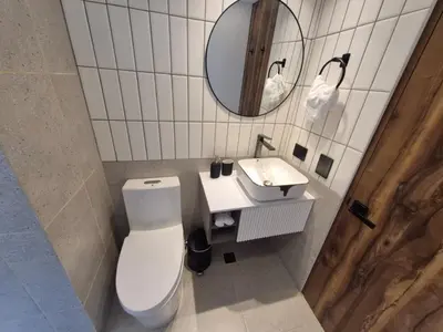a bathroom with a white toilet and a sink at Mali Experience in Rionegro