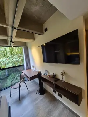 a living room with a large flat screen tv on the wall at Mali Experience in Rionegro