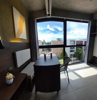 a room with a table and a large window at Mali Experience in Rionegro