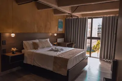 a bedroom with a large bed and a large window at Mali Experience in Rionegro