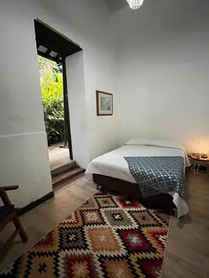 a bedroom with a bed and a rug at Hotel Art Boutique Las Cardenas in Carolina del Principe
