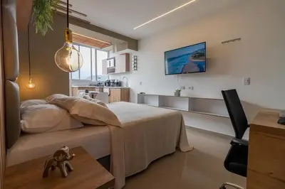 a bedroom with a bed and a table in a room at ApartaSuite Central Luxe in Itagüí