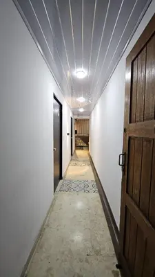 an empty corridor with a door and a hallway with a hallway at Hotel casa yotama in Medellín