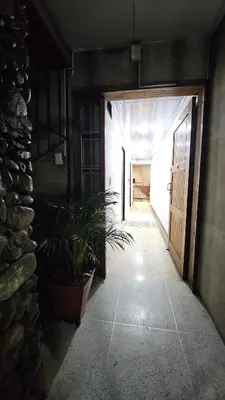 an empty hallway with a potted plant in a building at Hotel casa yotama in Medellín