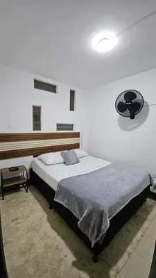 a bedroom with a large bed in a room at Hotel casa yotama in Medellín