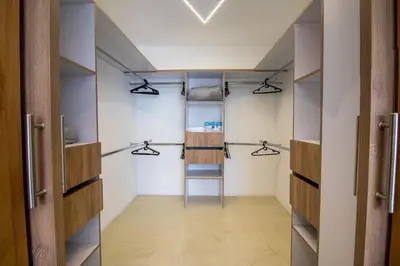 a walk in closet with shelves and a ladder at Penthouse de Lujo con Jacuzzi y Vista in Itagüí