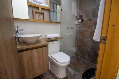a bathroom with a toilet and a sink and a shower at Penthouse de Lujo con Jacuzzi y Vista in Itagüí
