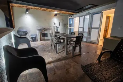 a living room with a dining room table and chairs at Penthouse de Lujo con Jacuzzi y Vista in Itagüí