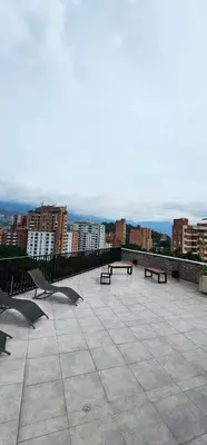 a patio with benches and a view of a city at Apartamento con excelente ubicación, Laureles in Medellín