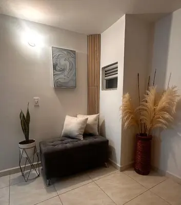 a couch sitting in a room with plants at Excelente Apartamento en Medellín sector Florida Nueva - Estadio in Medellín