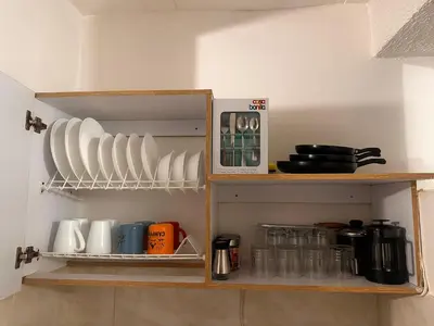 a shelf with plates and cups on it at Excelente Apartamento en Medellín sector Florida Nueva - Estadio in Medellín