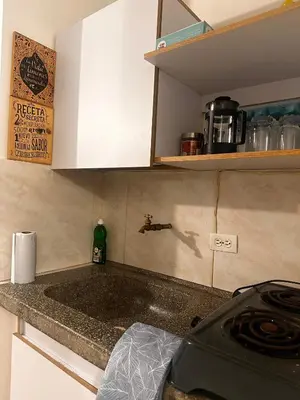 a kitchen counter with a sink and a stove at Excelente Apartamento en Medellín sector Florida Nueva - Estadio in Medellín