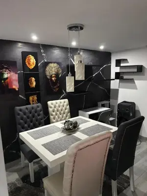 a dining room with a white table and chairs at Mirador Fiorenza in Medellín