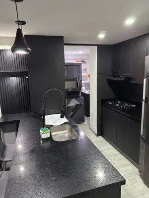 a kitchen with a sink and a counter top at Mirador Fiorenza in Medellín