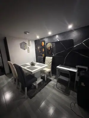 a dining room with a white table and chairs at Mirador Fiorenza in Medellín