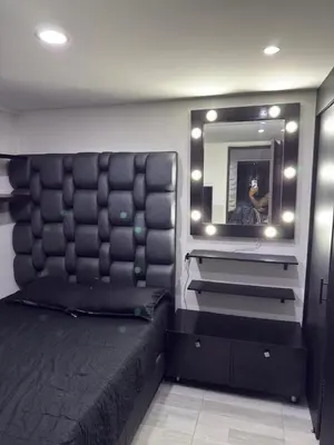 a bedroom with a large bed and a mirror at Mirador Fiorenza in Medellín