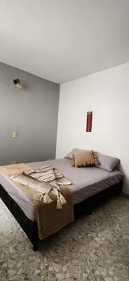 a bedroom with a large bed in a room at EmiliasHome Alojamiento amplio en Laureles in Medellín