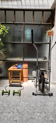 a room with a table and a treadmill and a table with weights at EmiliasHome Alojamiento amplio en Laureles in Medellín