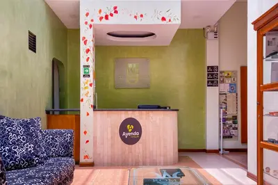 a waiting room with a couch and a counter at Ayenda 1140 Roma Plaza in Manizales