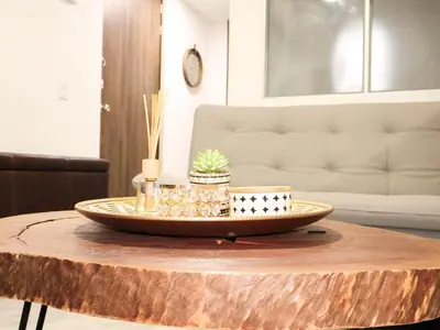 a coffee table with a tray on top of arified wood table at Apto estudio moderno en Sabaneta Ideal para pareja in Sabaneta