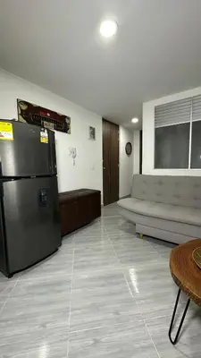 a living room with a refrigerator and a couch at Apto estudio moderno en Sabaneta Ideal para pareja in Sabaneta
