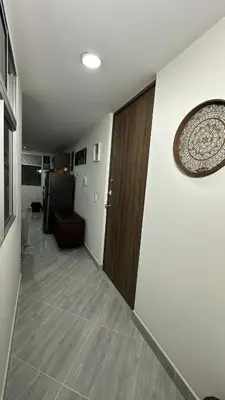 a hallway with a wooden door and a room at Apto estudio moderno en Sabaneta Ideal para pareja in Sabaneta