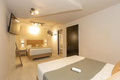 a hotel room with a bed and a bathroom at Hotel Garden Laureles in Medellín