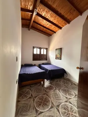 a room with two beds in a room at Finca La Carolina in Jericó