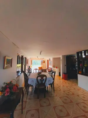a dining room with a table and chairs in a room at Finca La Carolina in Jericó