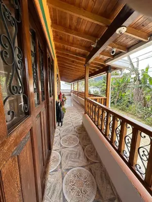 a balcony of a house with a wooden door at Finca La Carolina in Jericó