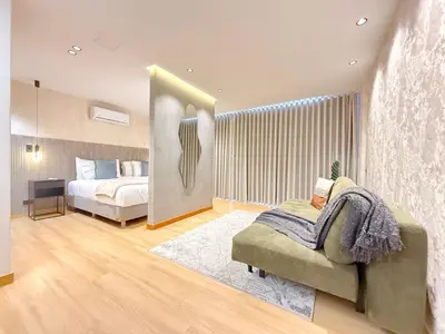 a bedroom with a bed and a chair in a room at Exclusive Studio El poblado in Medellín