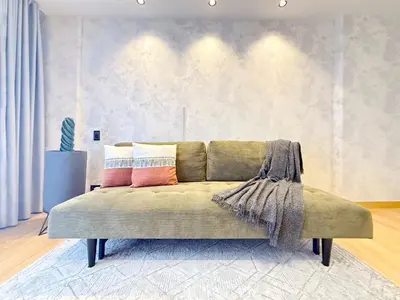 a couch with pillows on it in a living room at Exclusive Studio El poblado in Medellín