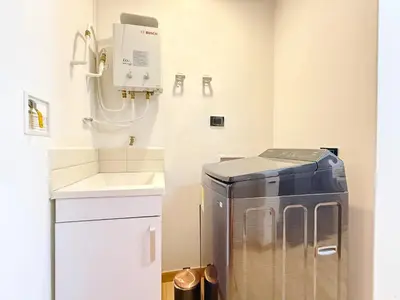 a laundry room with a washing machine and a sink at Exclusive Studio El poblado in Medellín