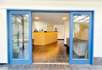 an office with sliding glass doors and a desk at Exclusive Studio El poblado in Medellín