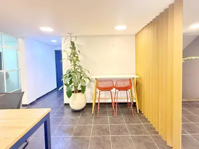 a room with two chairs and a table and a plant at Exclusive Studio El poblado in Medellín