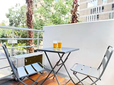 two glasses of beer sitting on a table on a balcony at Exclusive Studio El poblado in Medellín