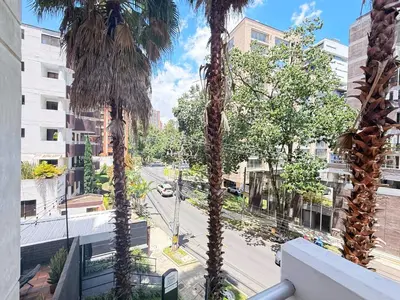 a view of a street from a balcony with palm trees at Exclusive Studio El poblado in Medellín