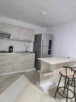a kitchen with a counter and a refrigerator at EstadioMedellin in Medellín