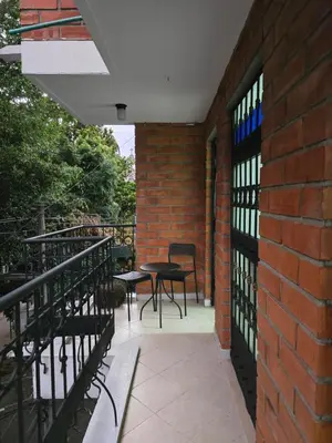 a balcony with a table and chairs and a brick wall at EstadioMedellin in Medellín