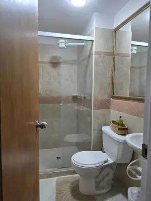 a bathroom with a toilet and a shower and a sink at EstadioMedellin in Medellín