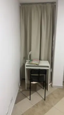 a desk with a chair next to a window at EstadioMedellin in Medellín