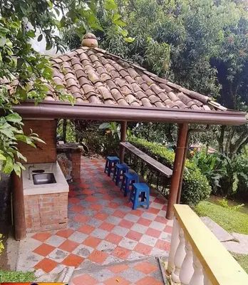 a gazebo with a bench and a grill at Finca Villa Palma in Barbosa
