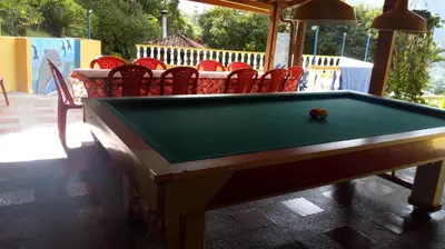 a pool table in front of a group of chairs at Finca Villa Palma in Barbosa