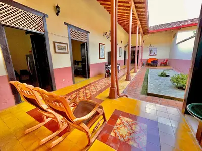 a living room with chairs and a pool in a house at Casa Real - Encanto Colonial in Sopetran