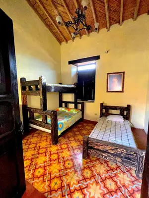 a room with two bunk beds and a tile floor at Casa Real - Encanto Colonial in Sopetran