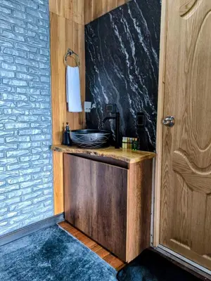 a bathroom with a sink next to a door at Cabaña con jacuzzi y vista al embalse - Ocasia in Chiquinquirá