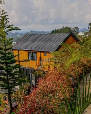 a yellow house with a black roof at Cabaña con jacuzzi y vista al embalse - Ocasia in Chiquinquirá
