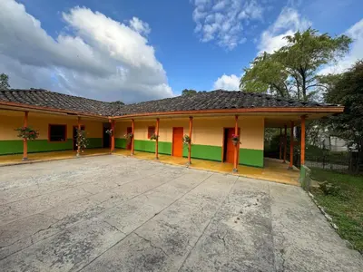 a house with a green and yellow at Casa de campo a 5 minutos from Sonsón in Sonsón